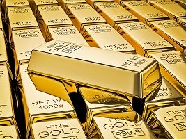 Gold bar on stacks of gold bullions close up